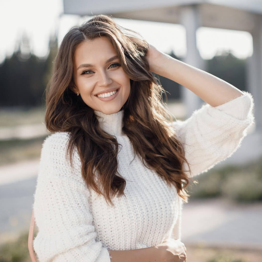 Woman smiling and showcasing her healthy, smooth skin after using Luxury Hair Removal Cream.